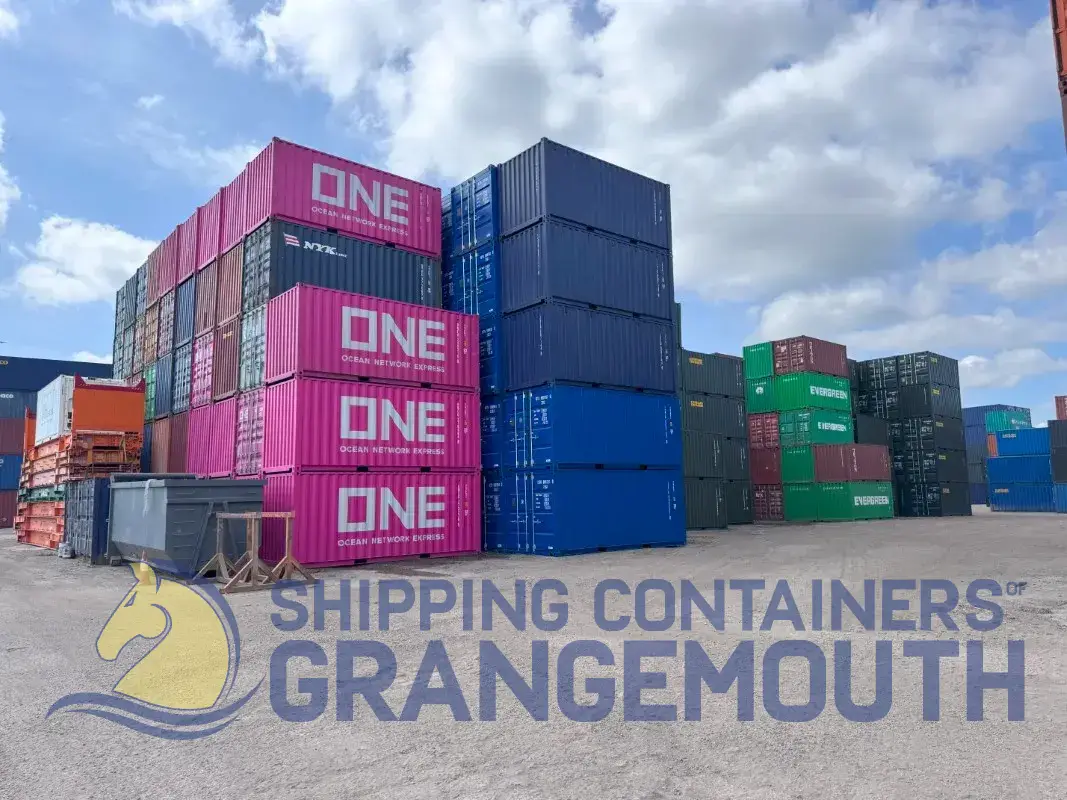 A stacked display of colorful shipping containers against a blue sky at Grangemouth.