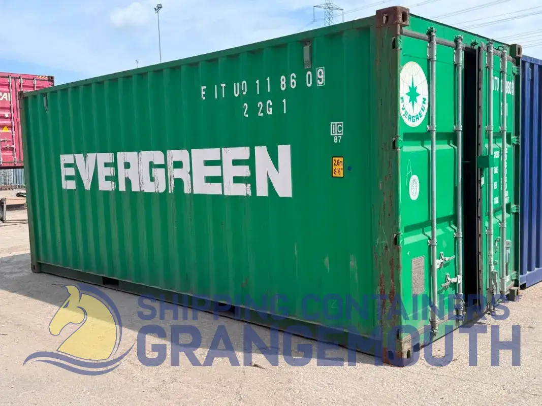 A green shipping container labeled 